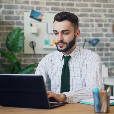 a man sitting in front of a laptop computer